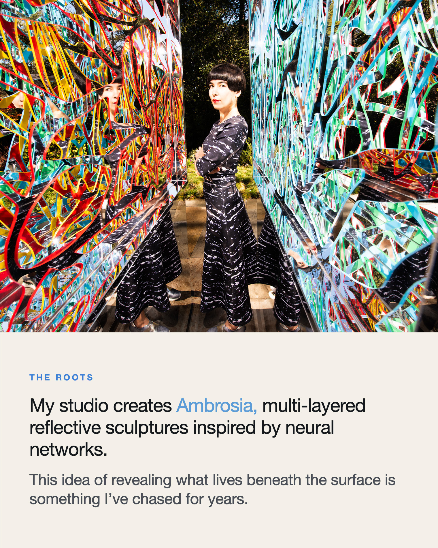 The Roots — Drue Kataoka between two Ambrosia sculptures, the studio's multi-layered reflective works inspired by neural networks