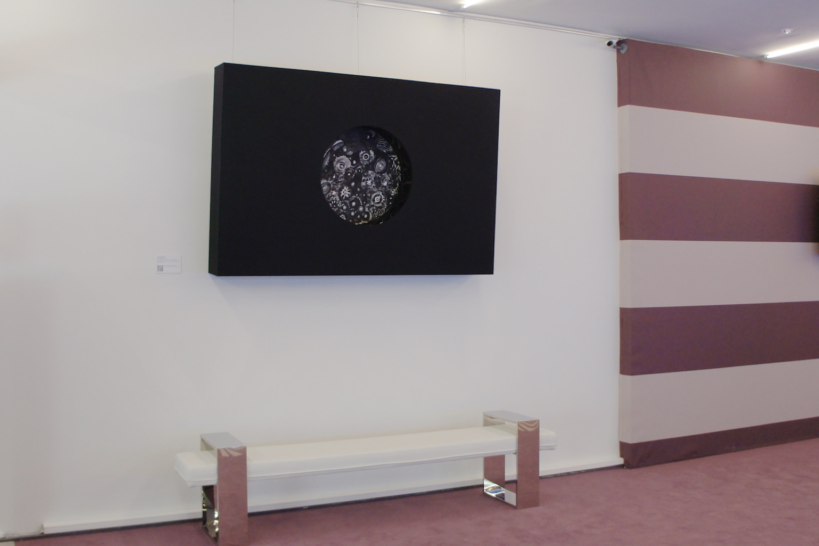 Skies of Atlantis — a Magic Box on a gallery wall: a black volume whose circular aperture reveals the hidden painting within
