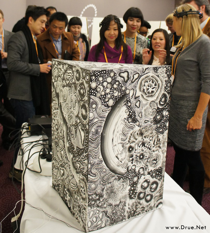 Viewers wearing EEG headsets gathered around the sumi-ink painted Tree of Pascal box at an exhibition