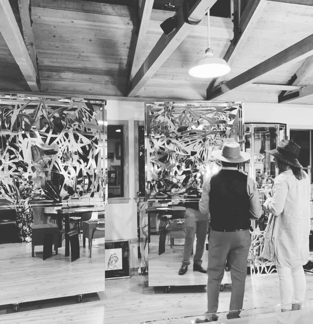 Collectors viewing Drue Kataoka's mirror-polished sculptural panels in the studio